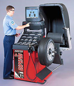 Picture of a mechanic and a wheel balance system