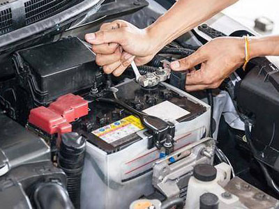 Picture of a mechanic working on a battery